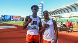 Ja’Kobe Tharp and Kayinsola Ajayi stand on the track in Auburn uniforms, posing at a stadium after their NCAA wins.